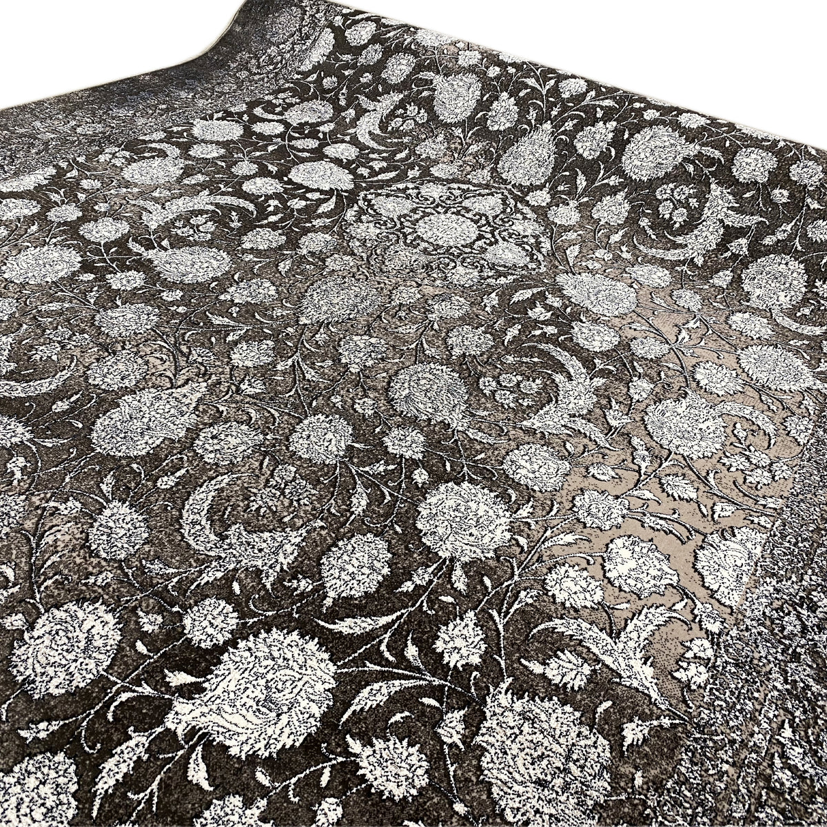 Close-up of 170x240 cm rug: silver floral ornaments on an anthracite background