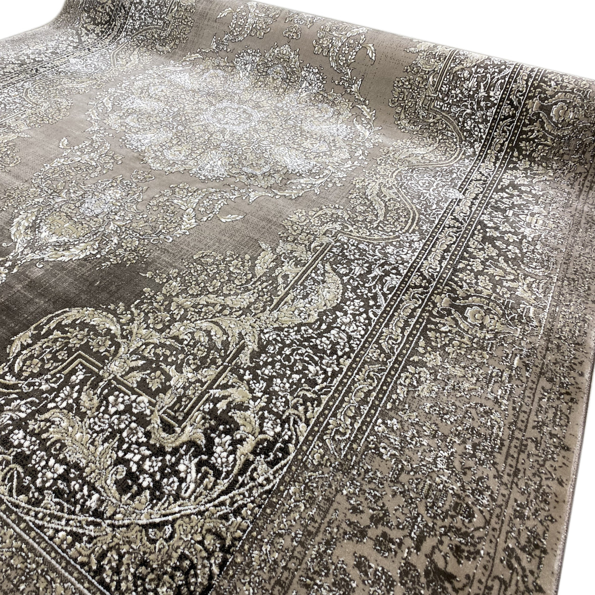 Close-up: medallion and decorative ornaments, silver-gray pattern on a dark carpet