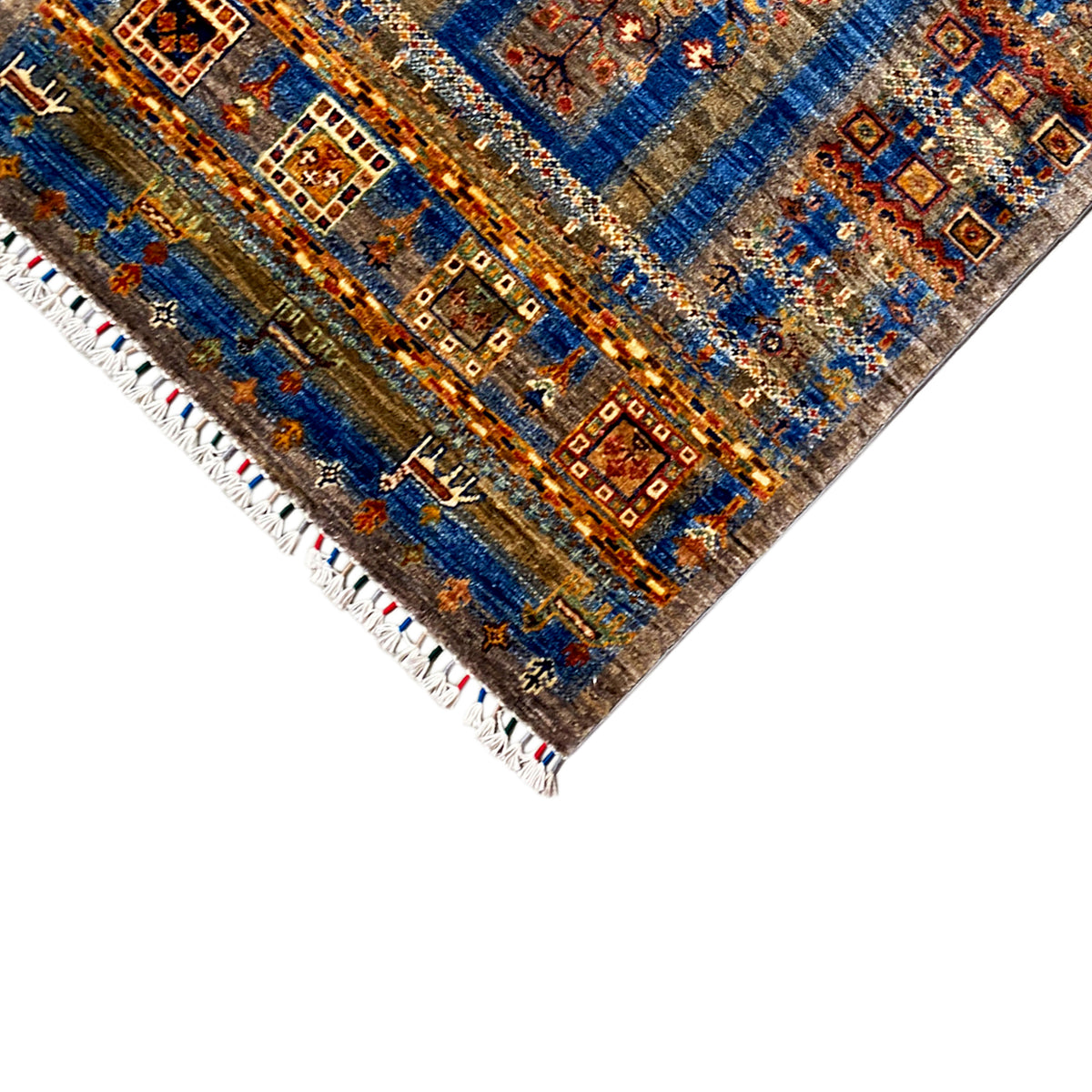 Corner with a blue-and-brown decorative border and patterned tiles, white fringe trim