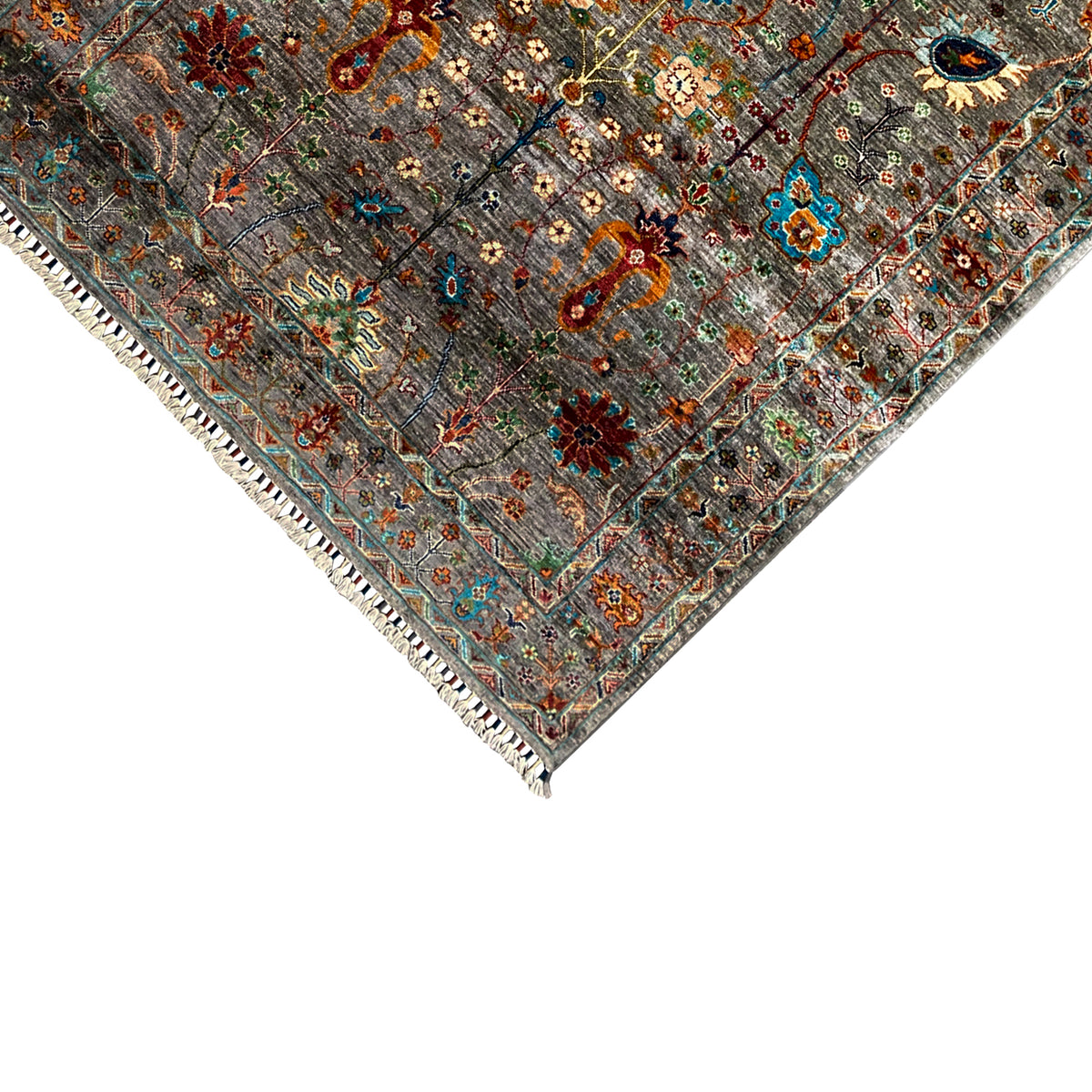 Corner detail of gray Khorjin rug: multicolored ornaments, hemmed edge with fringes
