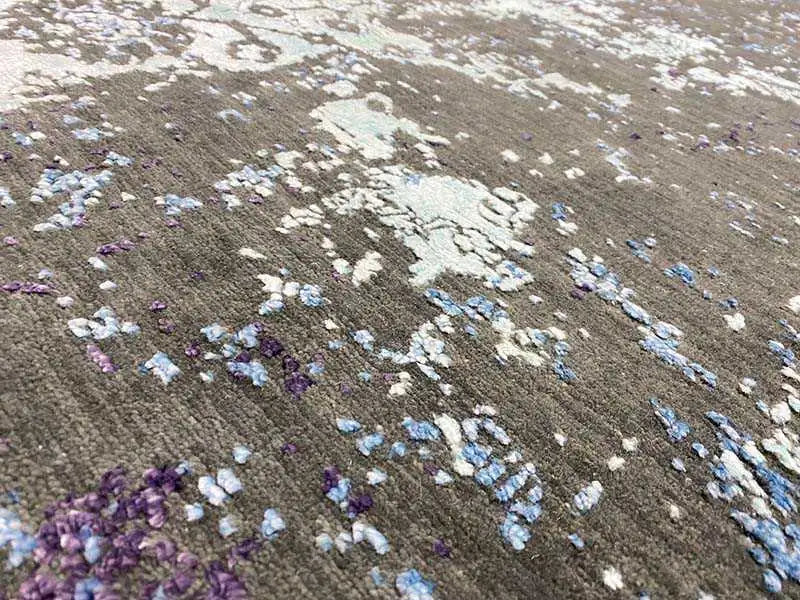 Carpet 185×122 cm close-up: vintage patches in purple, blue, and light gray.