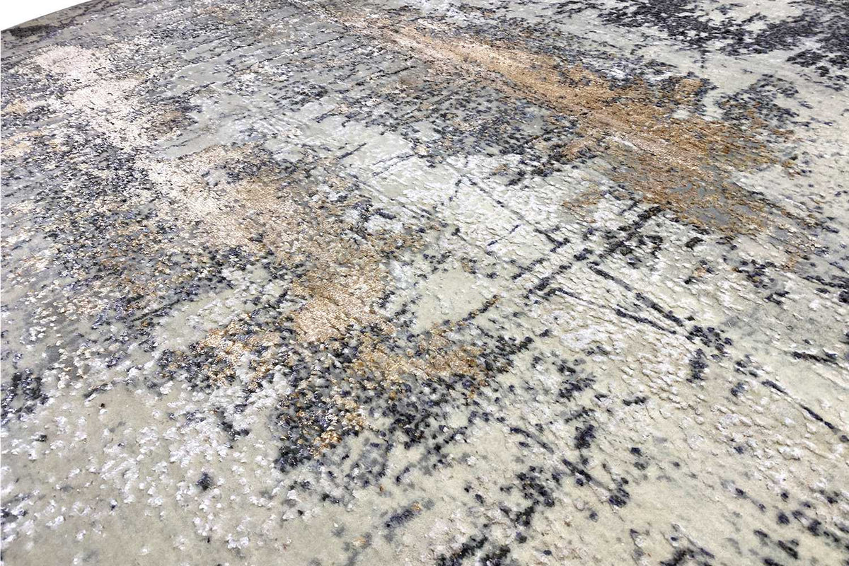 Detail of the carpet surface with an abstract pattern in light beige, gray, and brown
