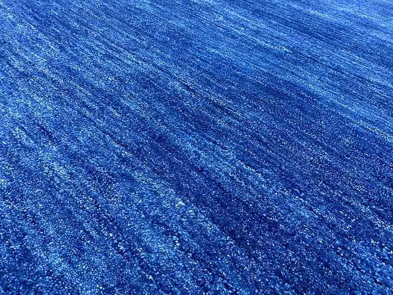 Blue Gabbeh rug 150x100 cm, close-up: mottled blue pile surface