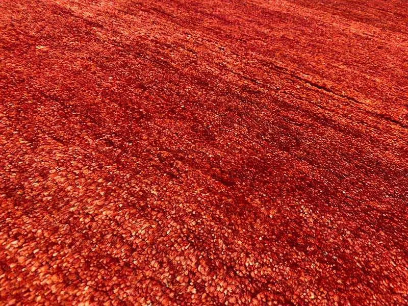 Gabbeh rug, close-up of the red pile texture with subtle color blends