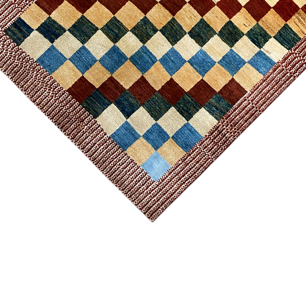 Gabbeh rug corner with a multicolored checkered pattern and reddish-brown decorative stitched border