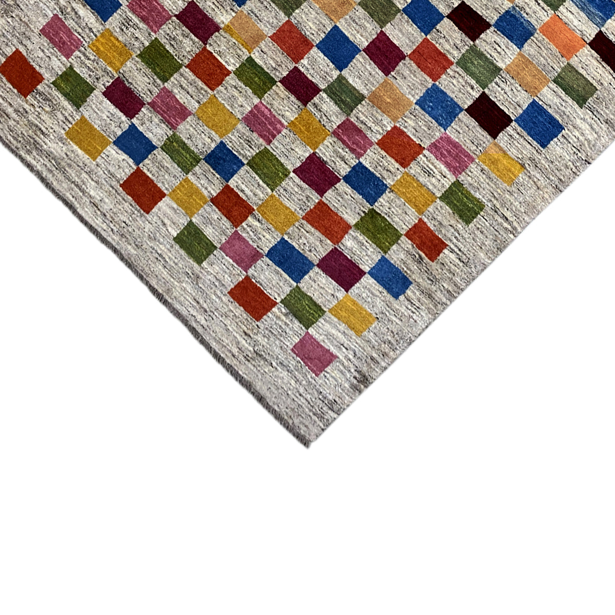 Gabbeh rug detail: geometric cube pattern on a light, mottled background