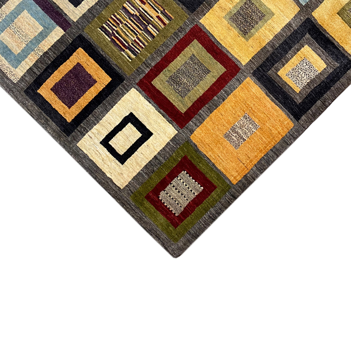 Gabbeh rug corner with square ornaments in ochre, green, blue and cream