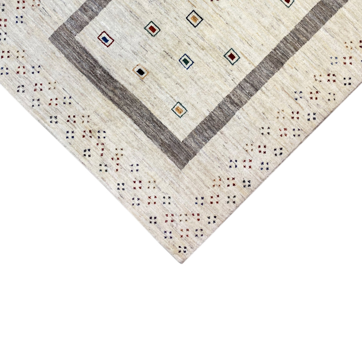 Close-up of the carpet edge with a gray central border and colorful ornamental dots