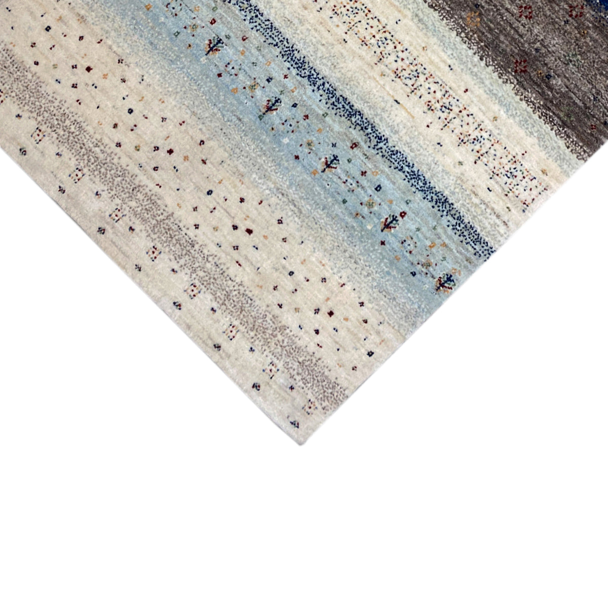 Close-up of a corner of a Gabbeh rug, light dots and small blue ornaments