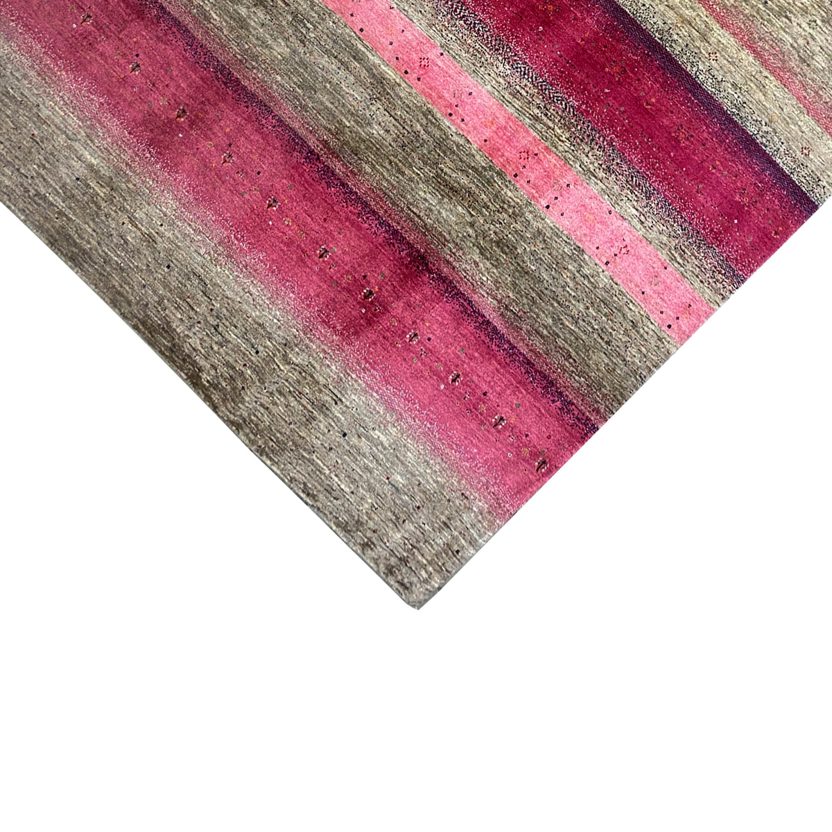 Gabbeh rug close-up: pink and gray stripes with a textured surface