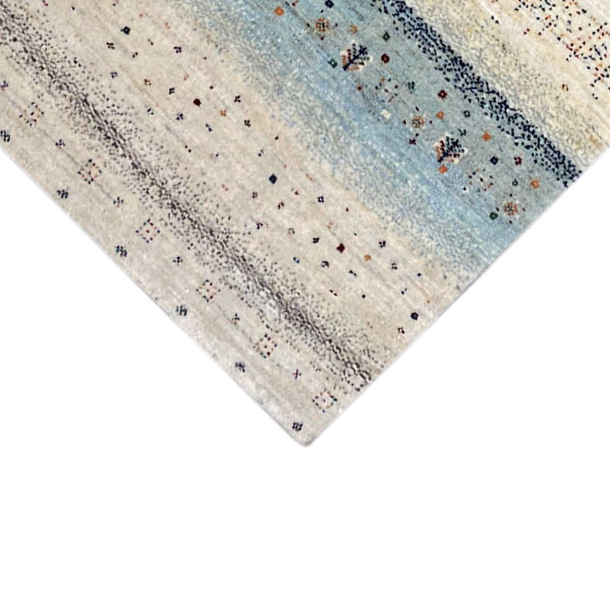 Gabbeh rug runner corner in detail: cream-colored background with blue ornaments