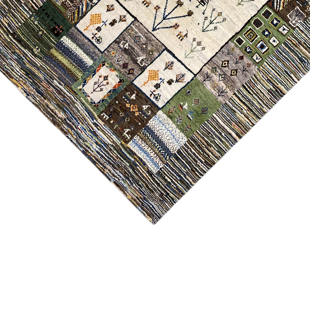 Detail of the carpet edge: patchwork squares with motifs, surrounded by multicolored stripes
