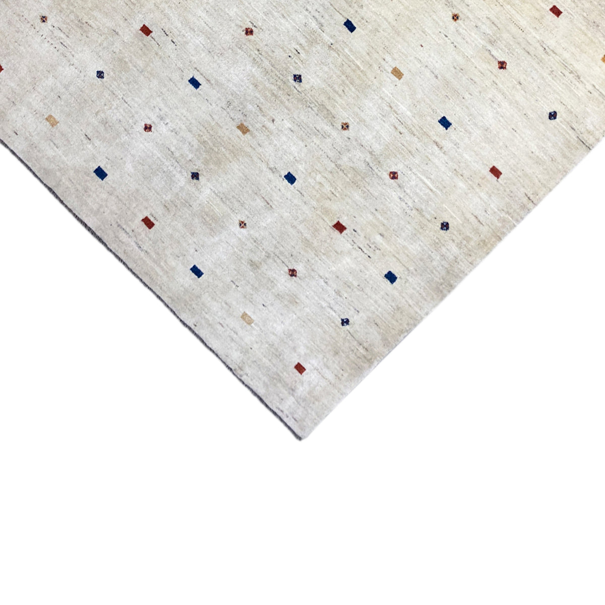 Gabbeh rug detail view: light beige pile with colorful squares