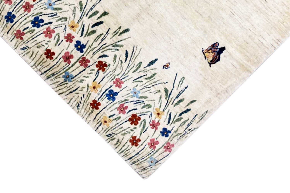 Gabbeh-Lori rug: corner with butterfly and floral vine in blue, red, and green
