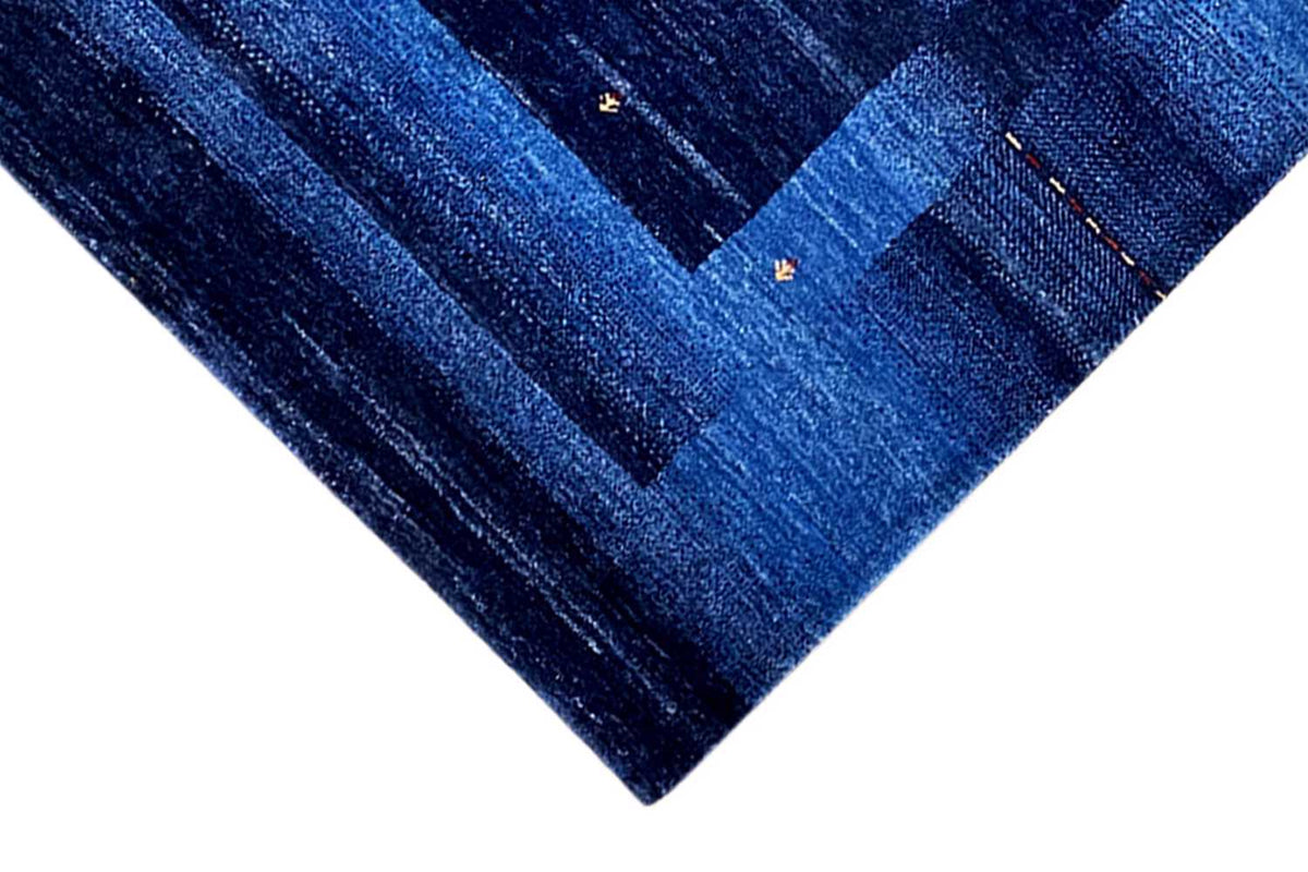 Blue Gabbeh rug, detailed view: dark and light blue stripes with small dots