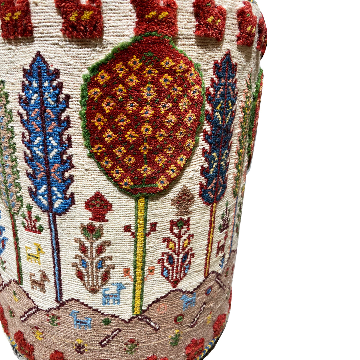 Colorful Soumakh stool: close-up of the patterned upholstery with ornamental trees