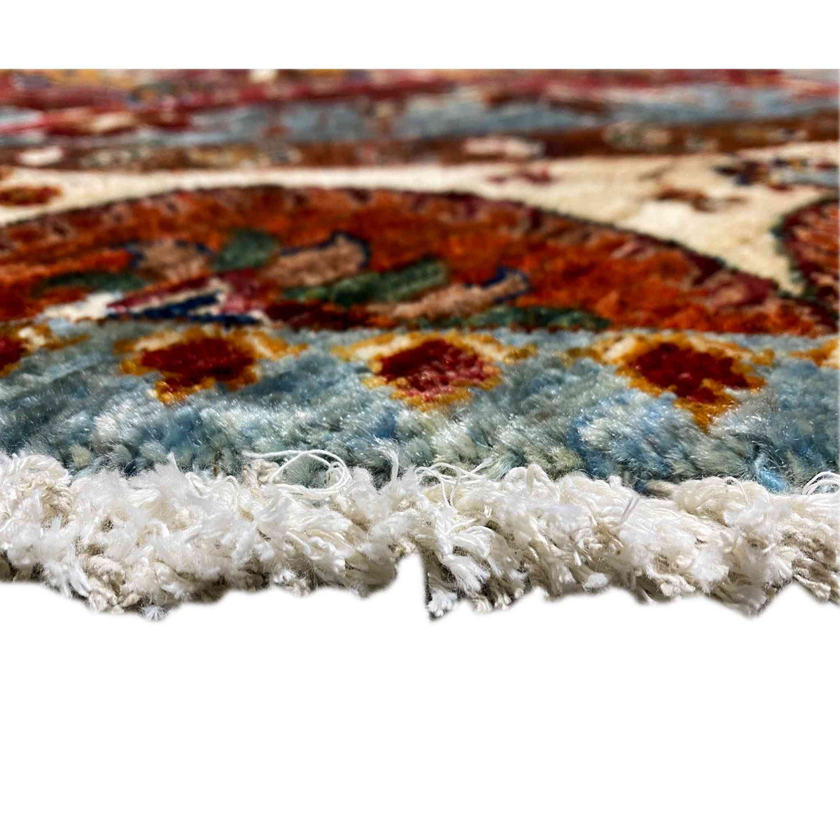 Octagonal shaggy rug with fringed edges, multicolored pattern.