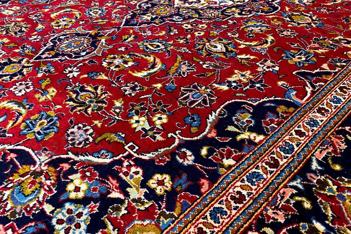 Keshan Oriental rug 286x195 cm close-up: colorful ornament on a red background