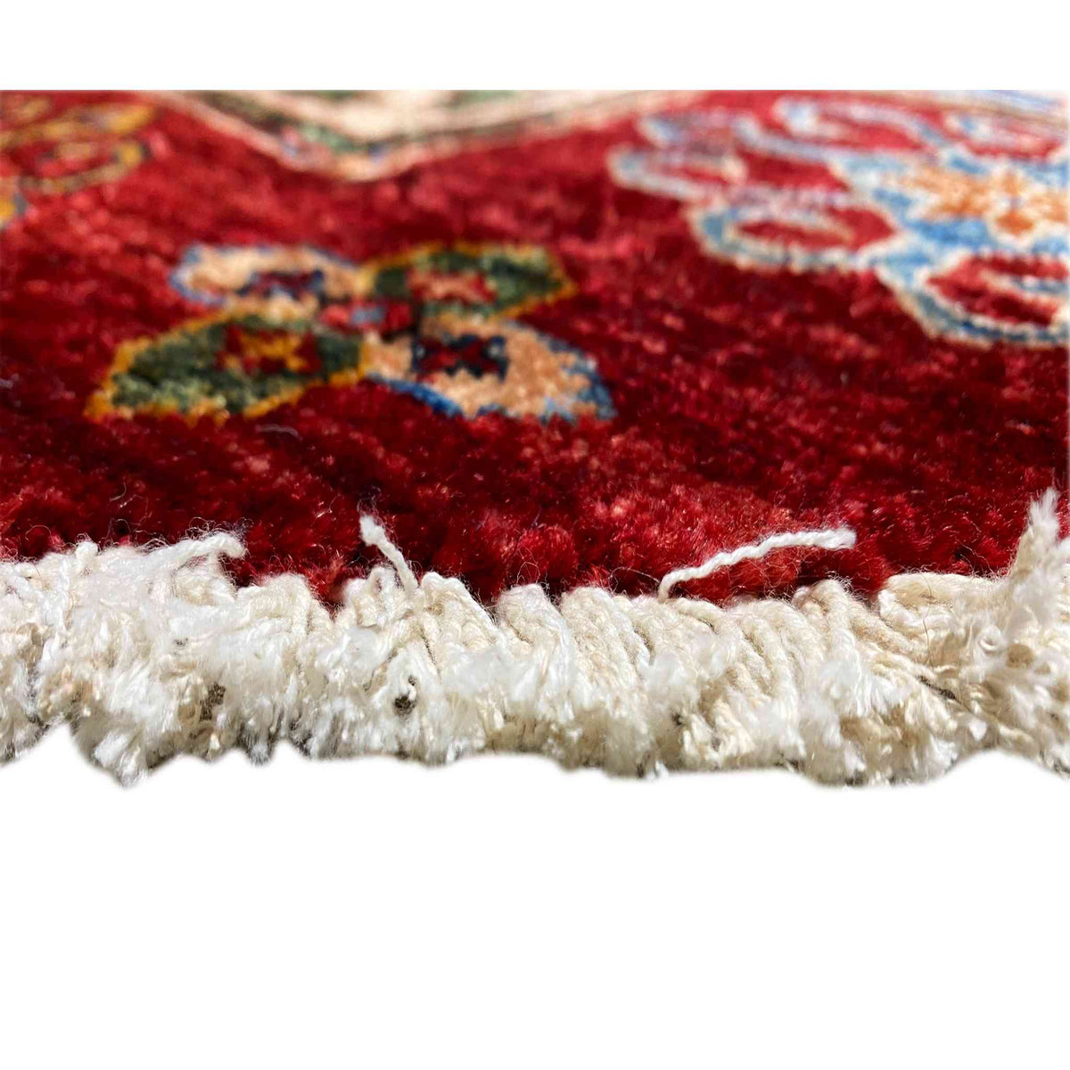 Carpet edge with white fringed trim and red pile