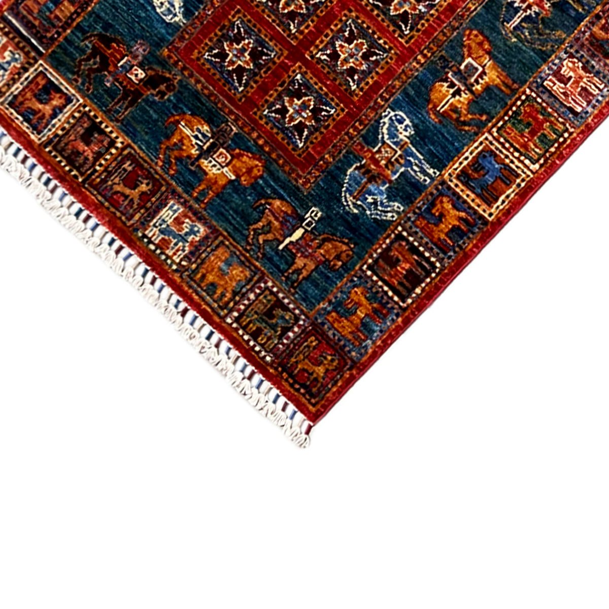 Edge detail with tassels on the hand-knotted Khorjin runner, blue field with animal motifs.