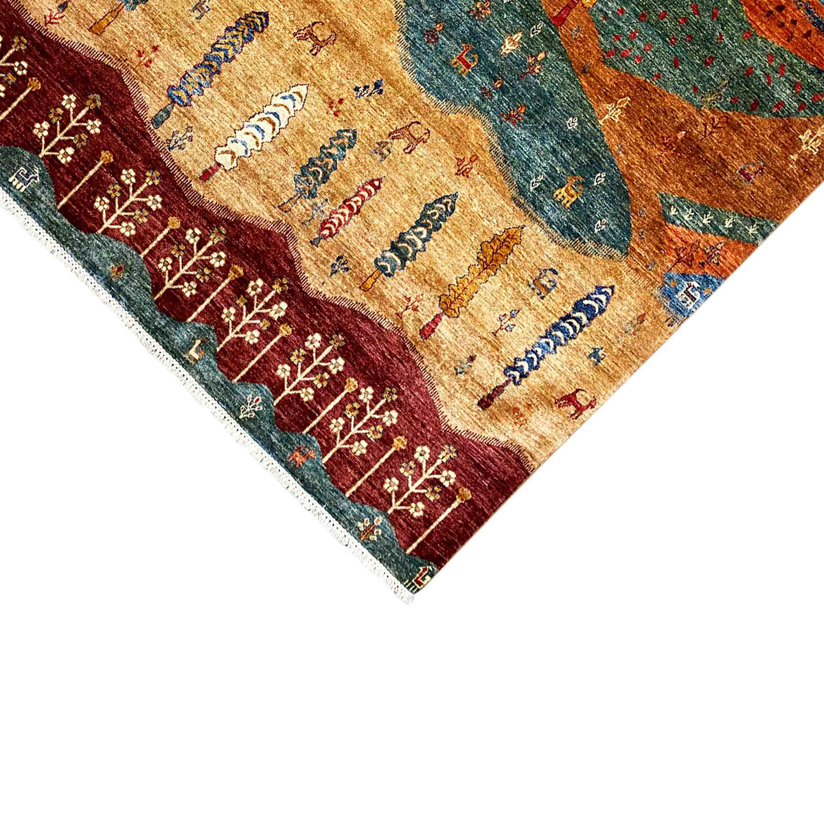 Detail of the carpet edge with an embroidered row of trees, colorful motifs, and a light-colored finishing trim.
