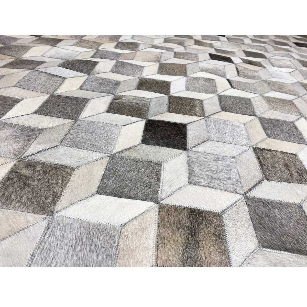 Calfskin rug with a 3D cube pattern, textured in gray, white, and black