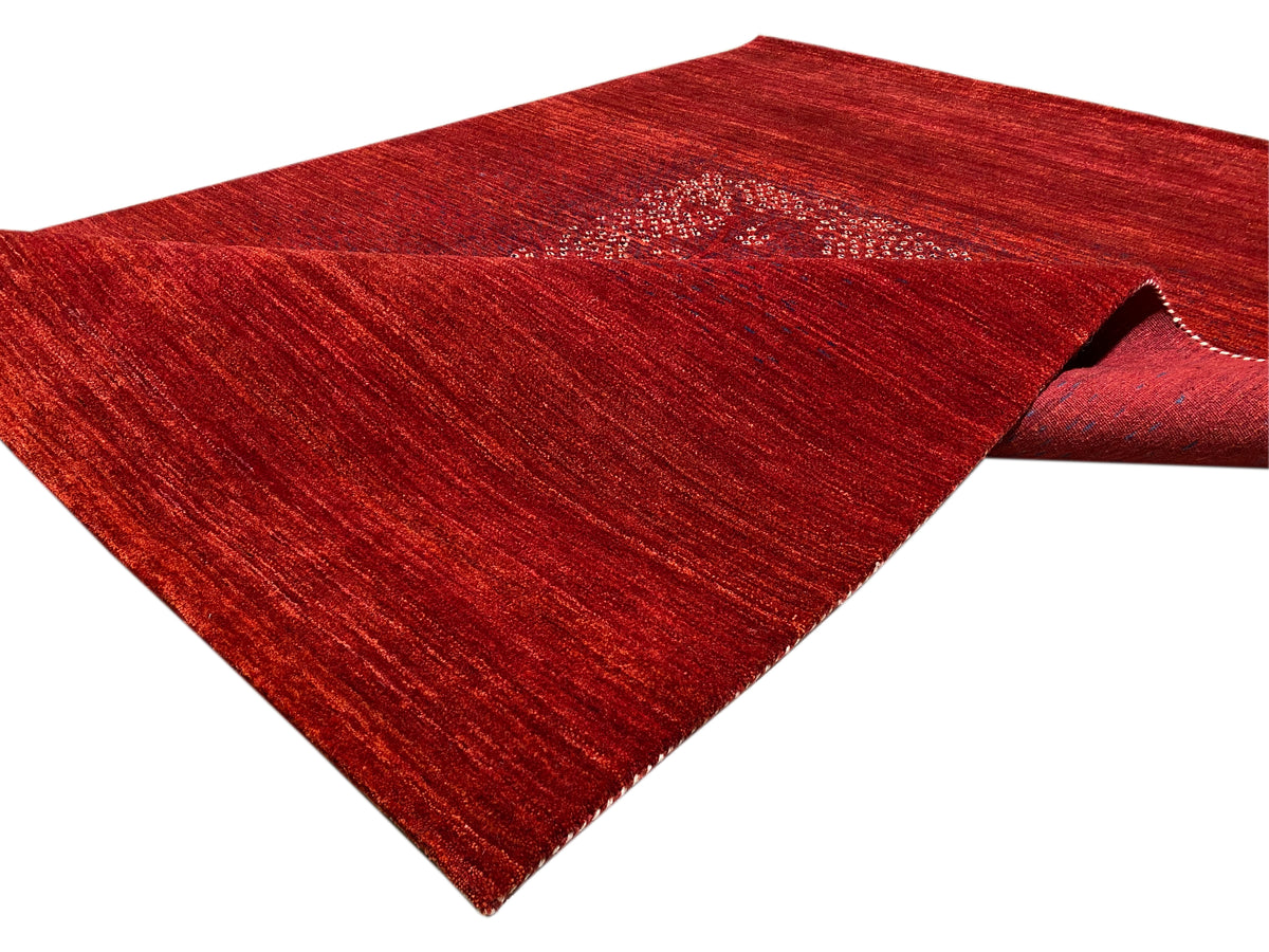 Rug with rolled edge: reddish-brown pile surface and medallion in the upper section