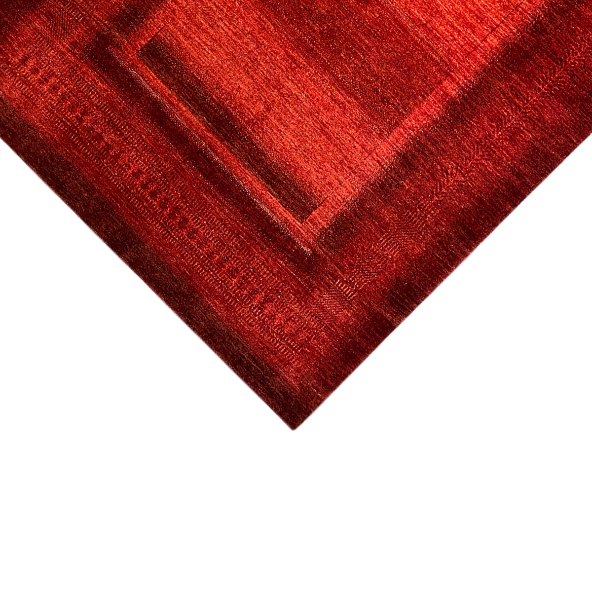 Gabbeh-Luri rug in red with a geometric pattern, diagonal close-up of the surface