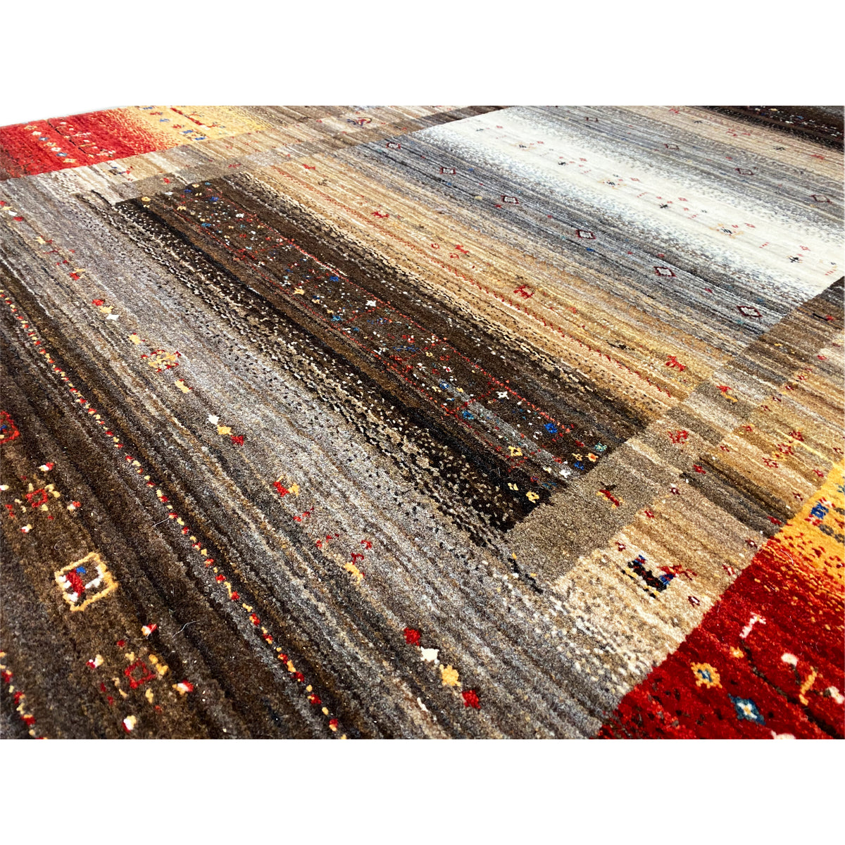 Close-up of a carpet surface with fine color flecks in brown, gray, beige, and red