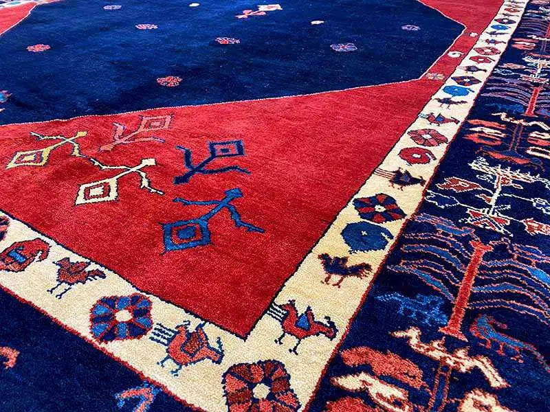 Carpet detail: blue center, red field, and border strip with ornaments
