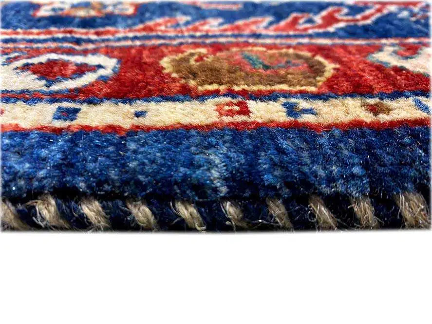 Oriental rug detail: colorful woven patterns at the edge with fringes