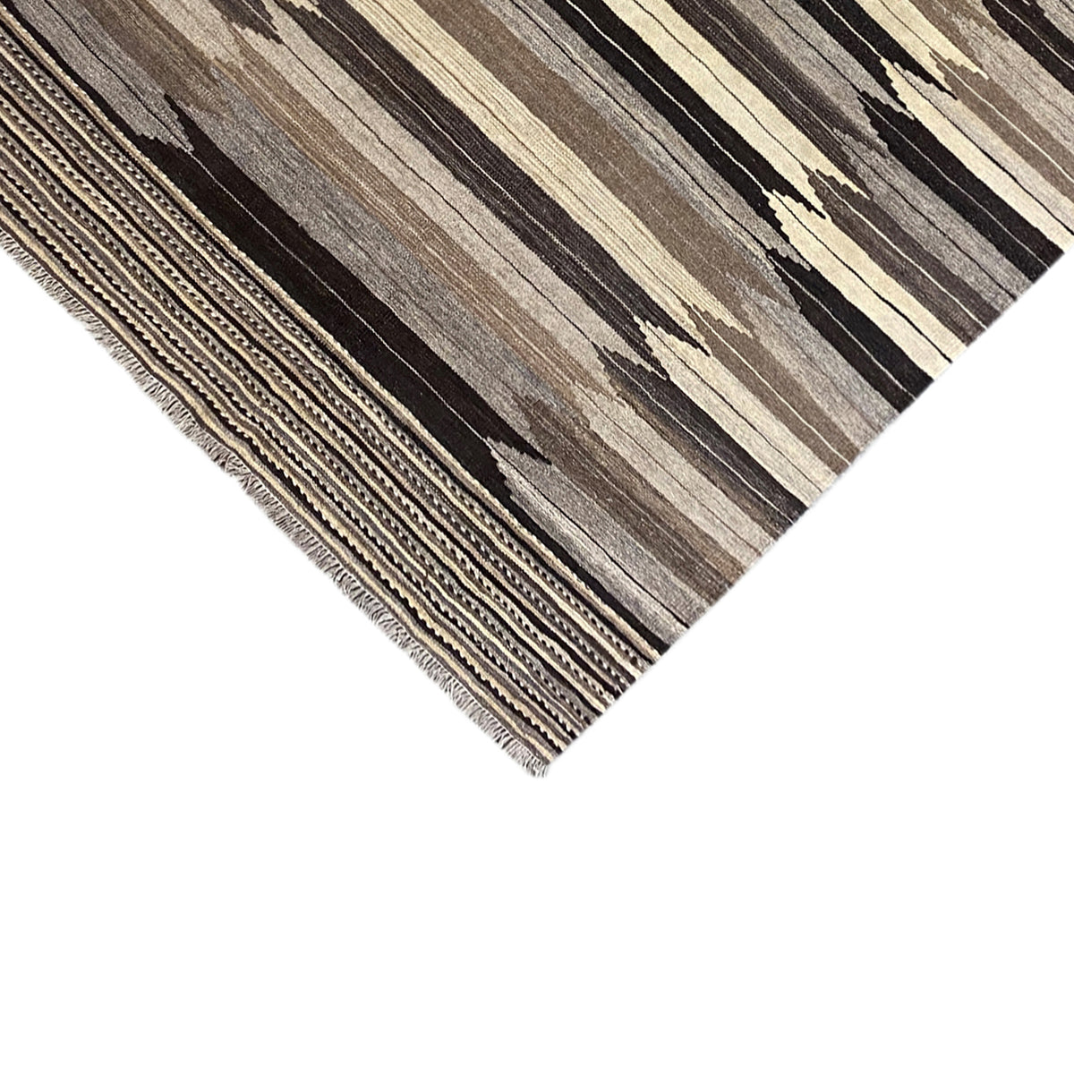 Carpet corner with fringes and border, striped pattern in gray, beige, and dark brown