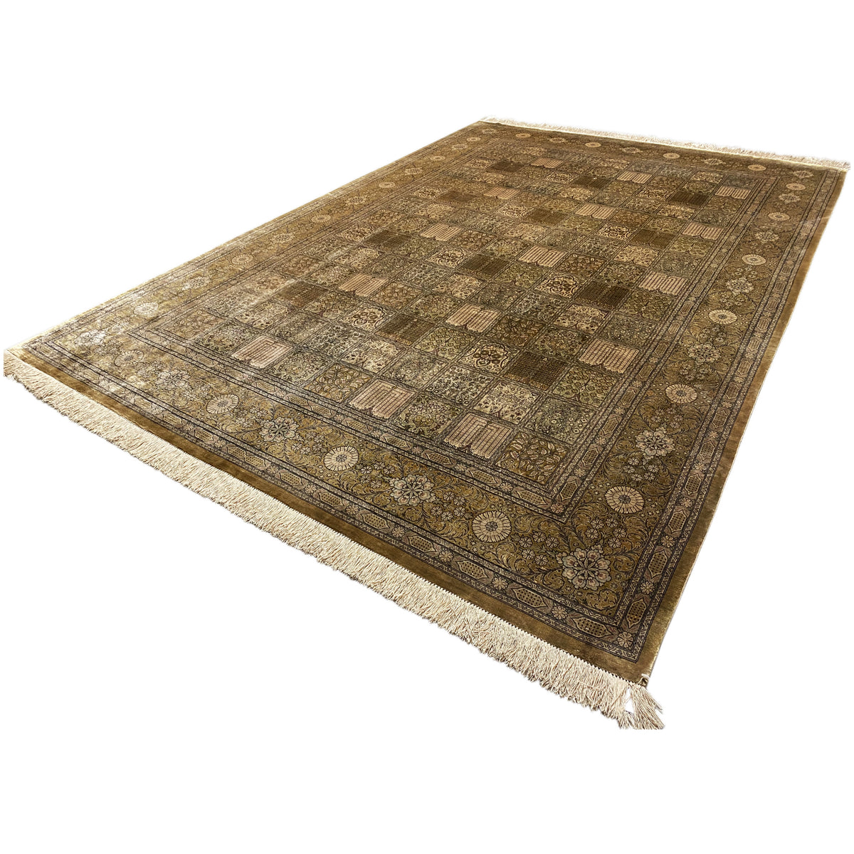 Rectangular Ghom rug with a beige/brown patchwork design and fringes along the edge