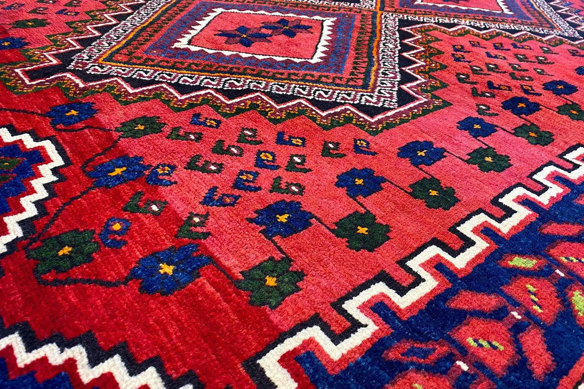 Sirjan rug, red with a geometric pattern and colorful motifs, 243×176 cm
