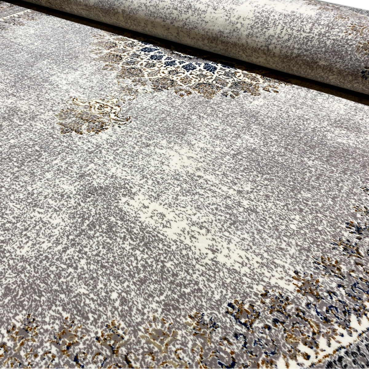 Close-up of the vintage rug: fine pile with patterned, grainy color accents