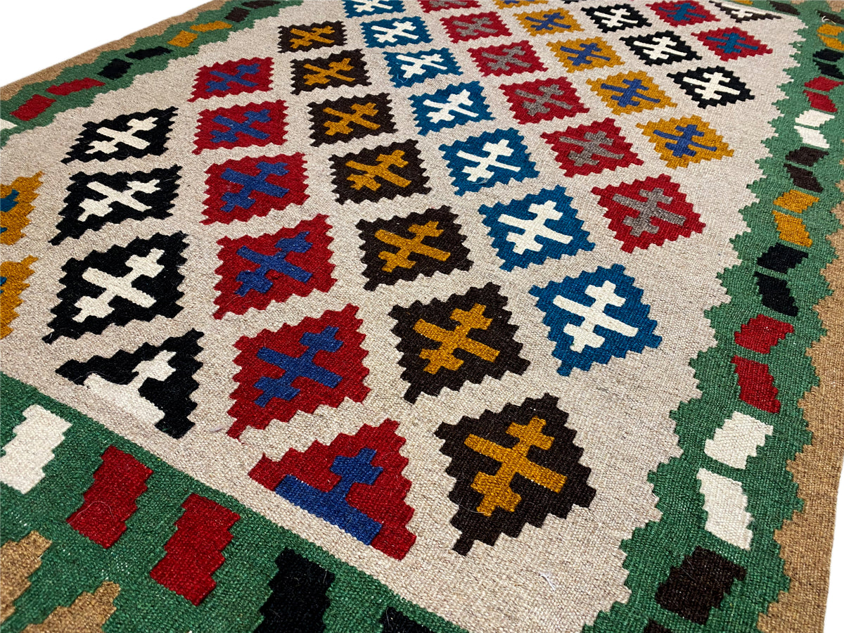 Kelim Qashqai rug detail: Cross and diamond motifs in red, blue, yellow, and black