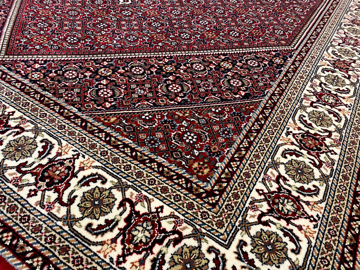 Pattern details: red carpet with framed ornaments and a border