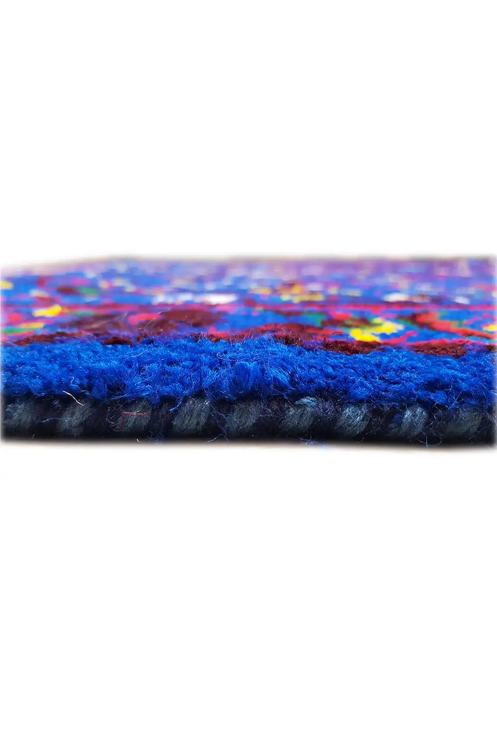 Close-up: hem with fringe on the blue silk cloth, colorful pattern visible