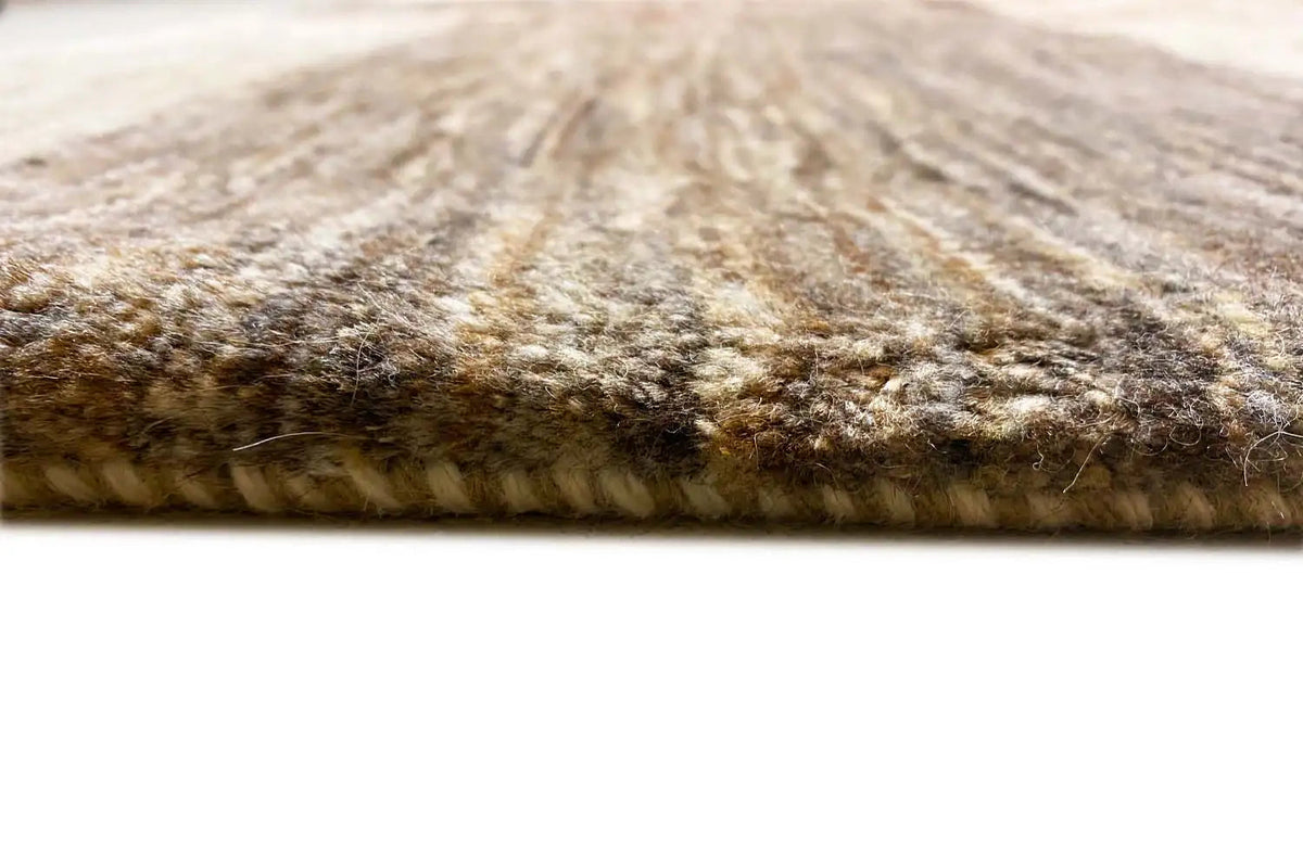 Gabbeh Lori rug with visible pile at the edge, light beige and gray tones