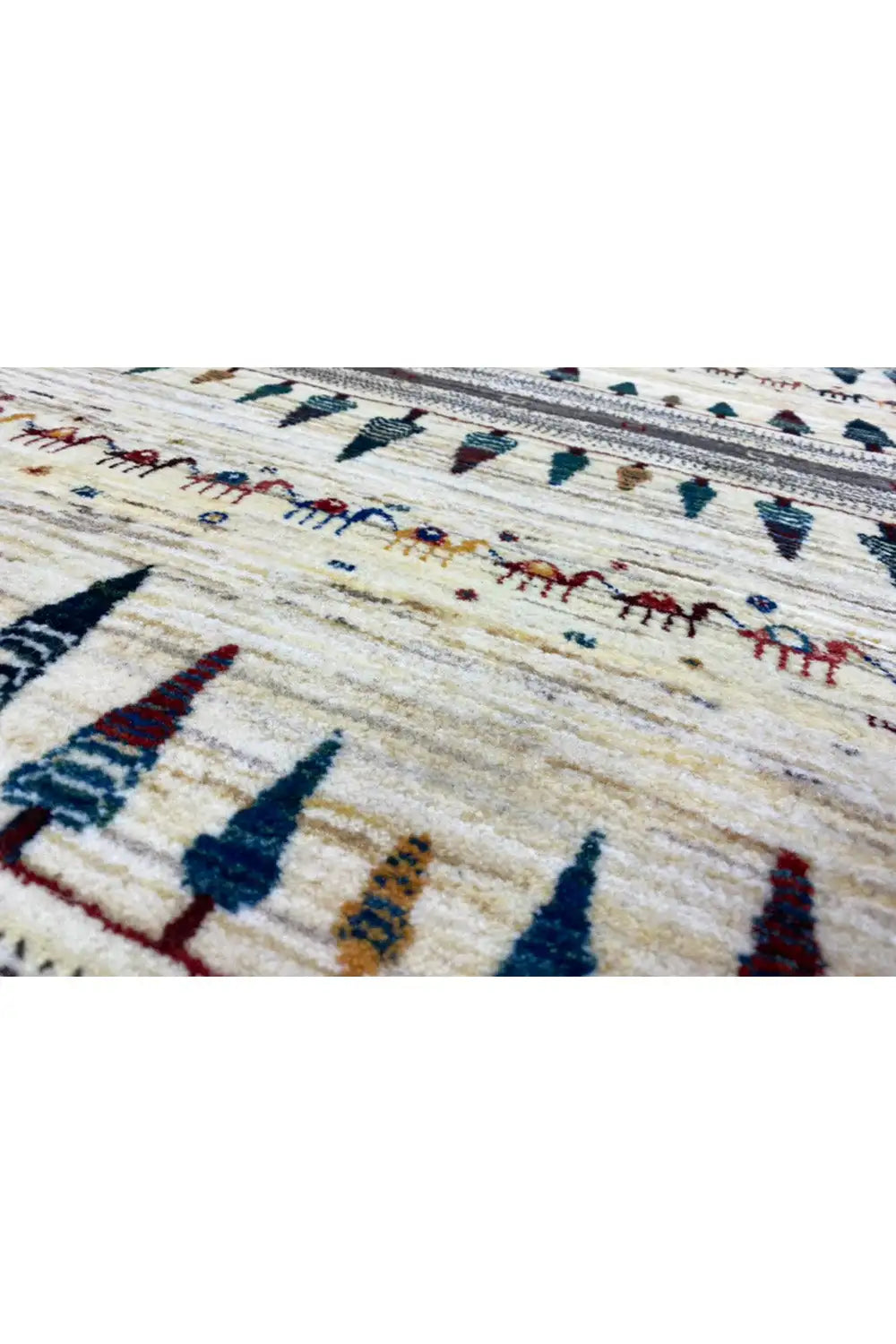 Gabbeh rug, close-up: cream background with dark blue and red arrow motifs