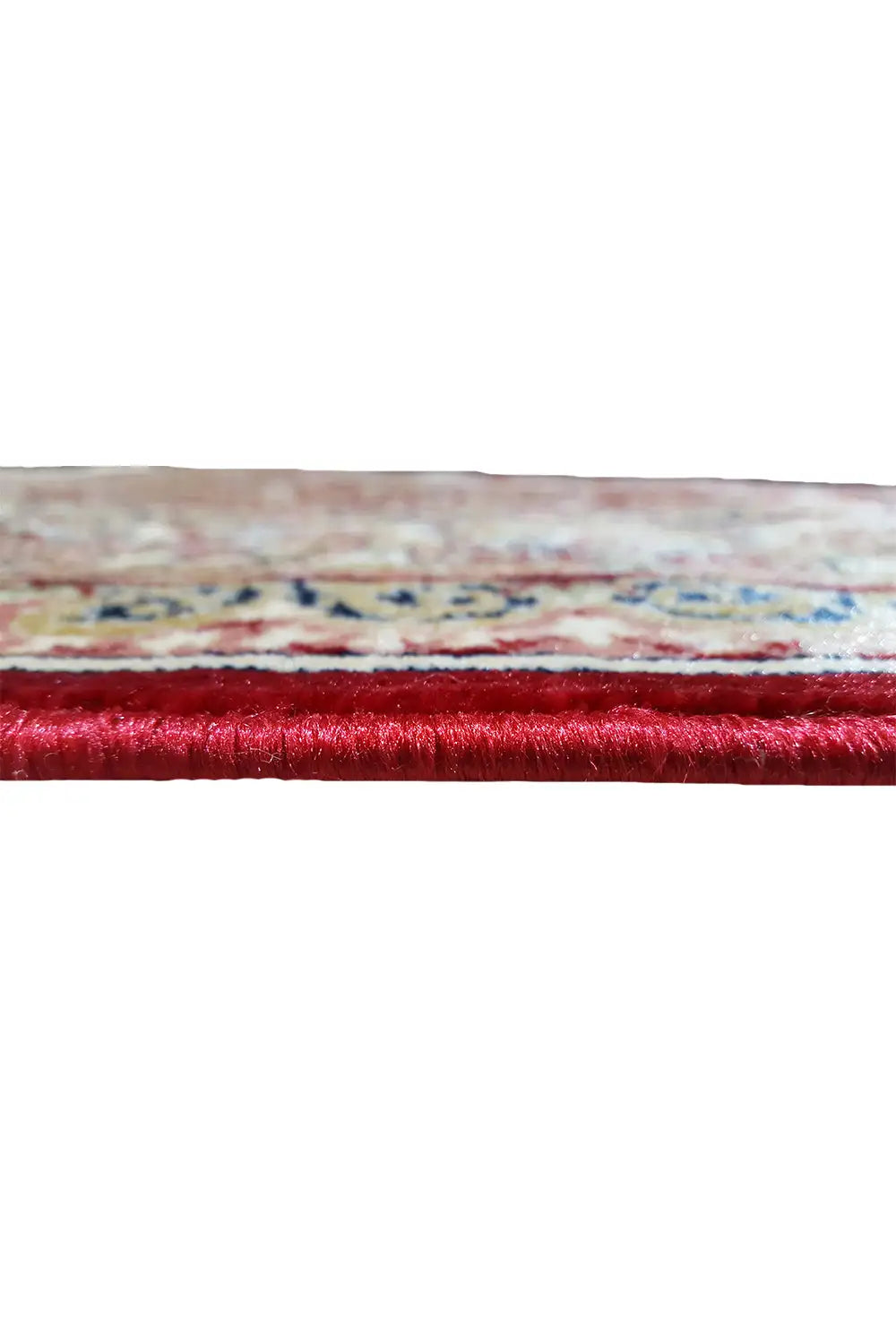 Carpet edge in detail: red pile with multicolored shading and hem