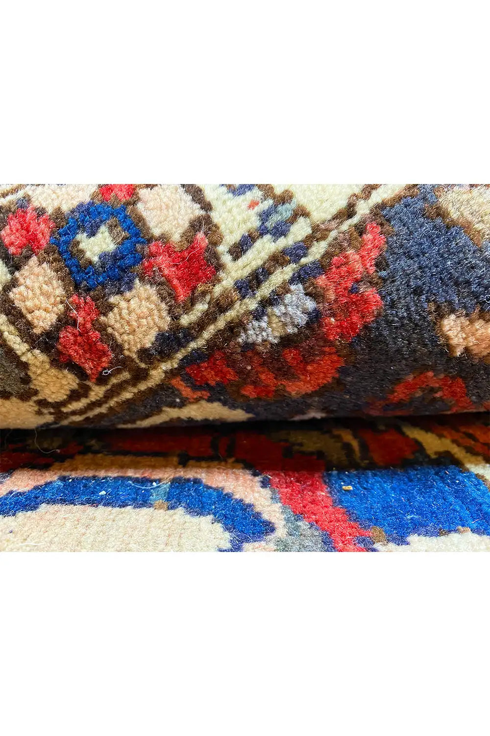 Carpet detail with multicolored woven texture and ornaments, cropped at the side