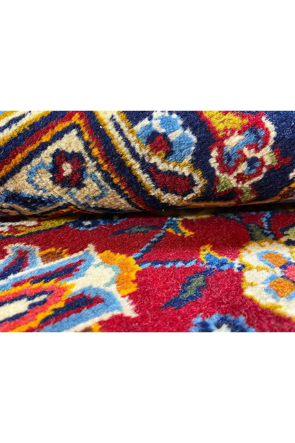 Close-up of a carpet design: colorful ornaments with blue-red pile