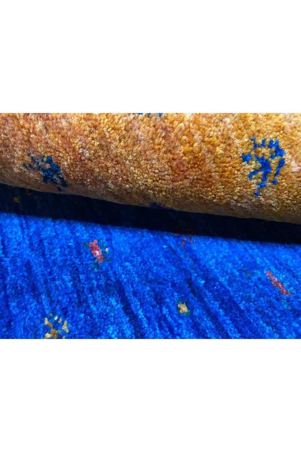Gabbeh rug close-up of the selvedge: yellow and blue with colorful knot points