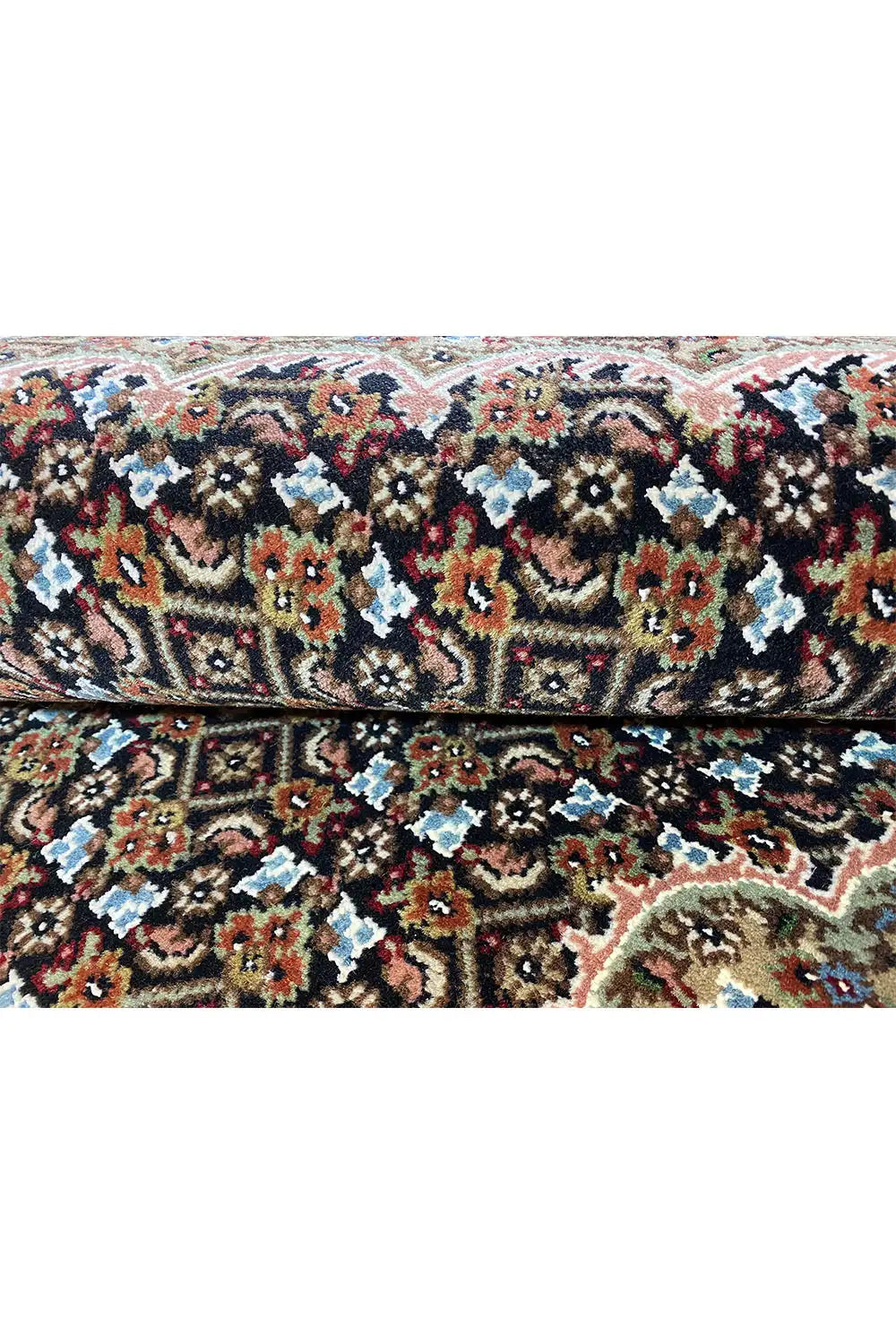 Carpet surface with a detailed pattern in black, red, blue, beige and green