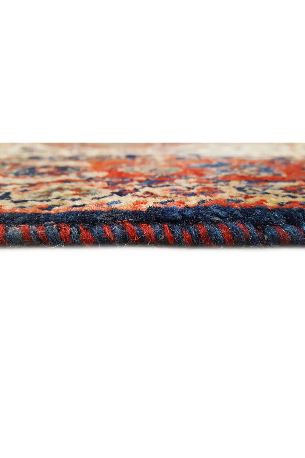 Carpet fringe along the edge, dark blue and red pile with colorful accents