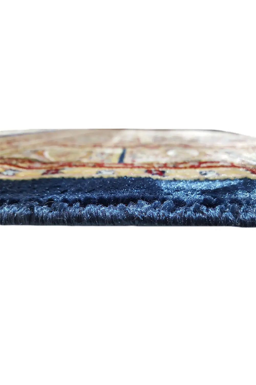 Machine-woven carpet edge view: pile and seam, multicolored border with dark pile