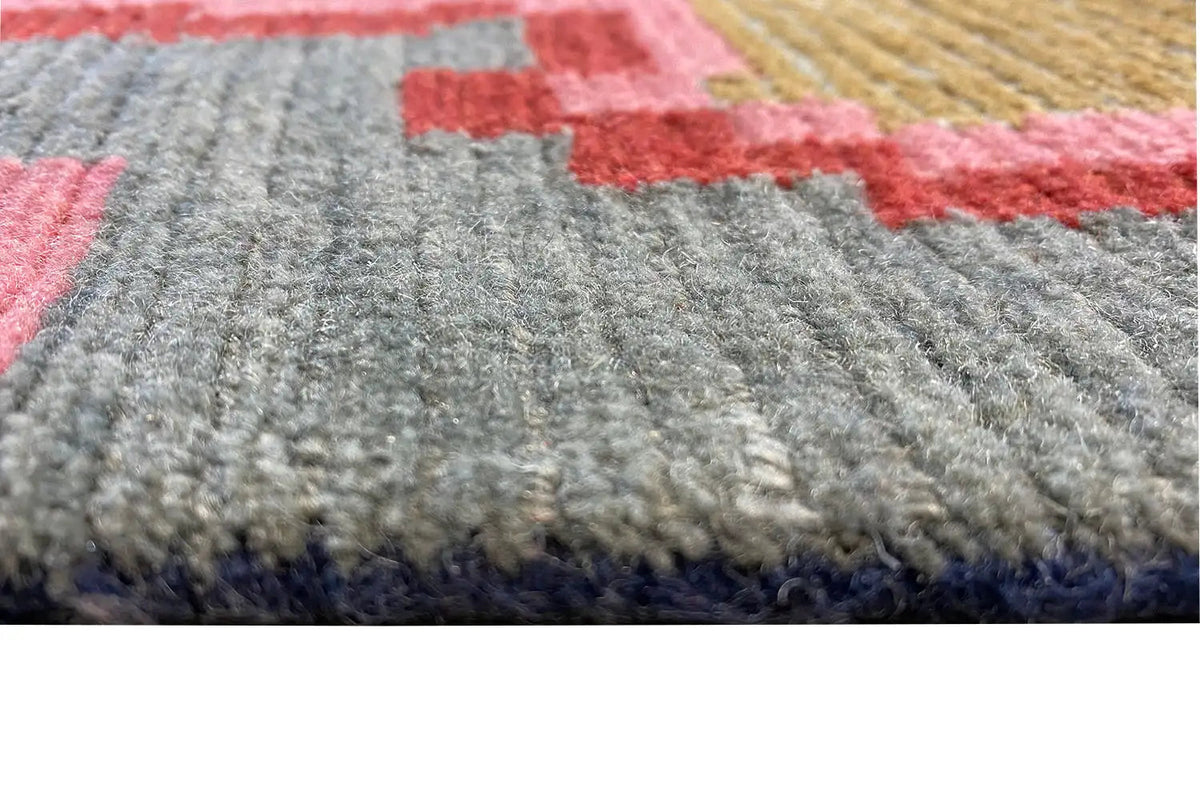Designer rug with gray pile and colorful patterned areas in red and blue
