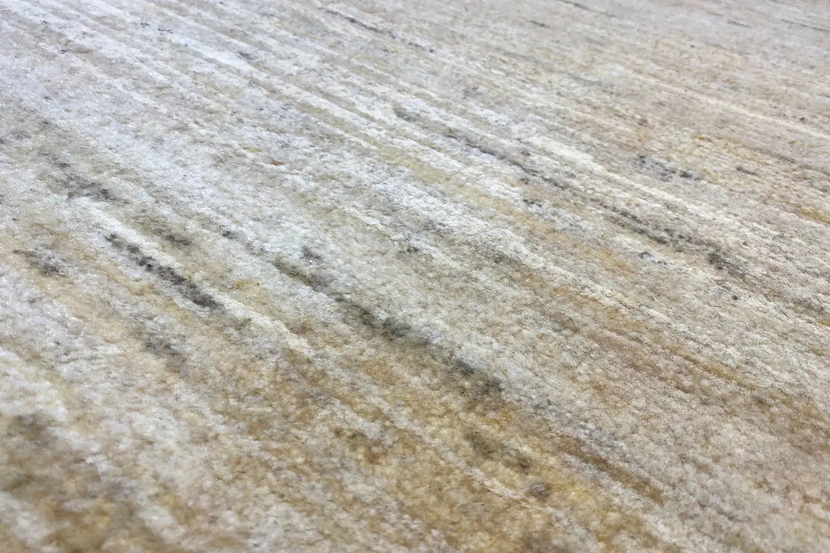 Gabbeh rug surface with fine, light lines and a mottled weave pattern