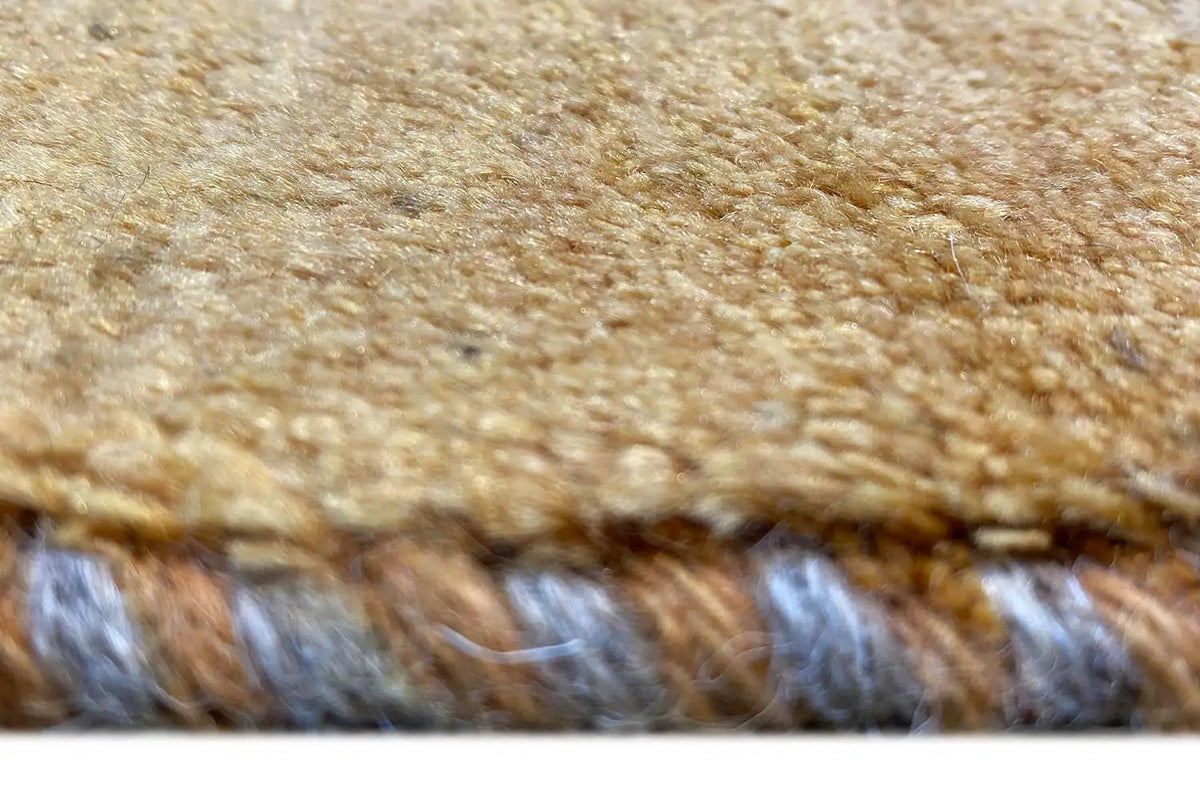 Gabbeh rug (153x97 cm) close-up: fringe and pile texture in ochre brown